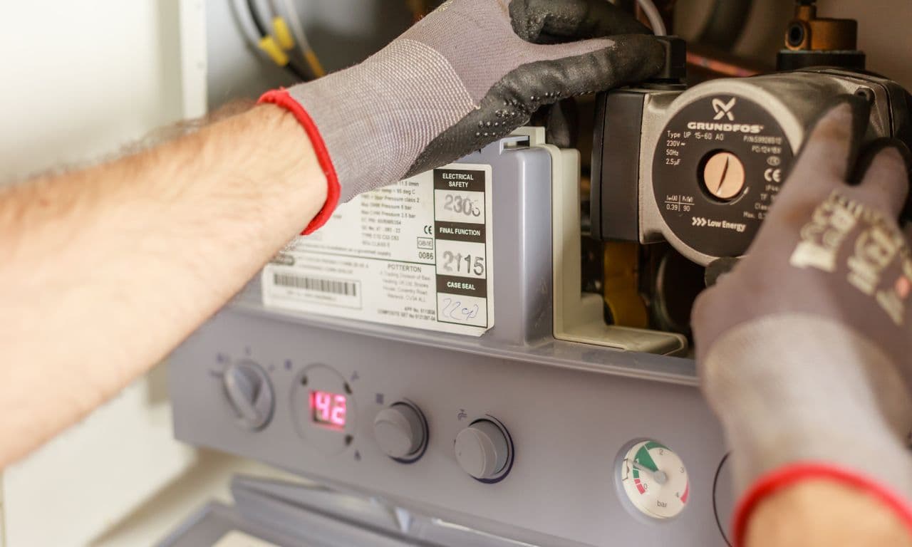 Engineer adjusting a domestic combi boiler