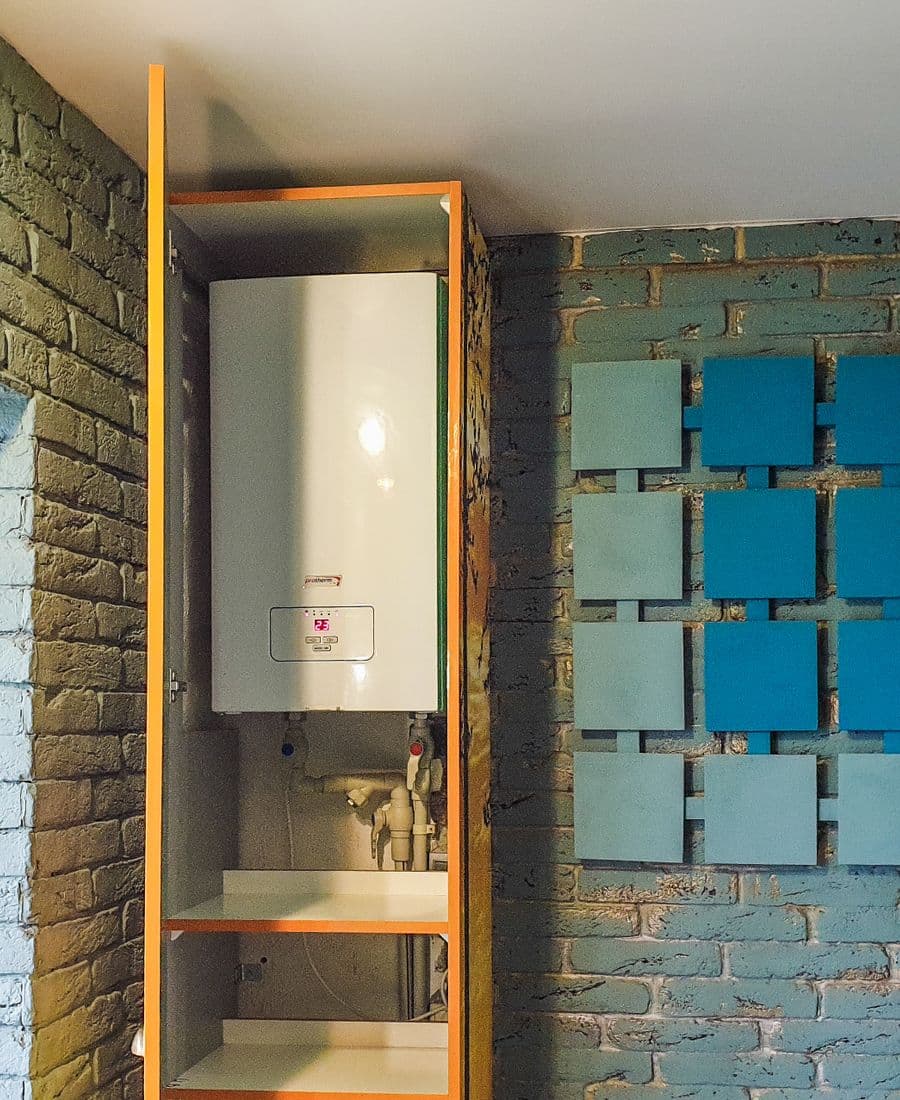 Wall-mounted residential boiler installed in a cabinet