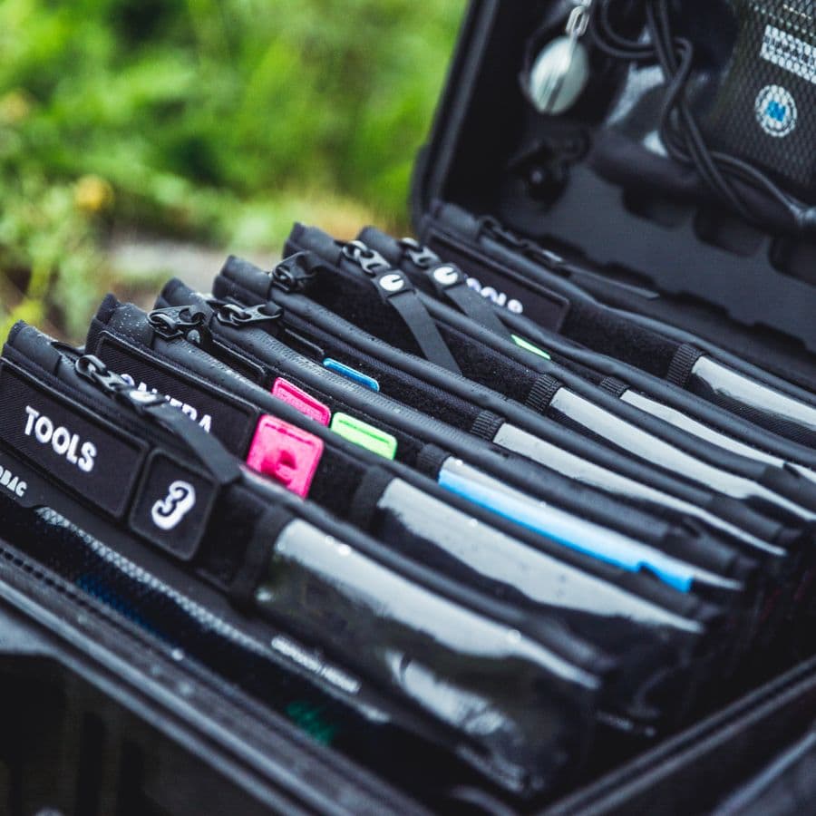 Top-down close-up of an organised tool bag with labelled pockets