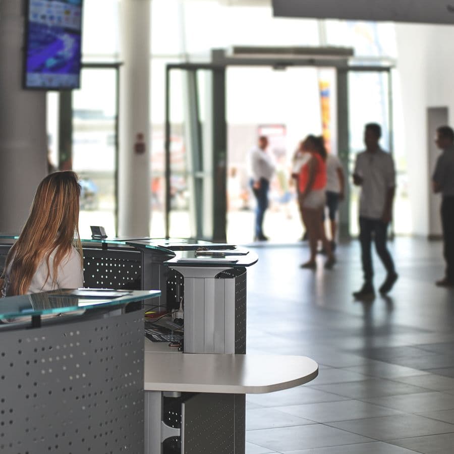 Receptionist sitting at a small business front desk